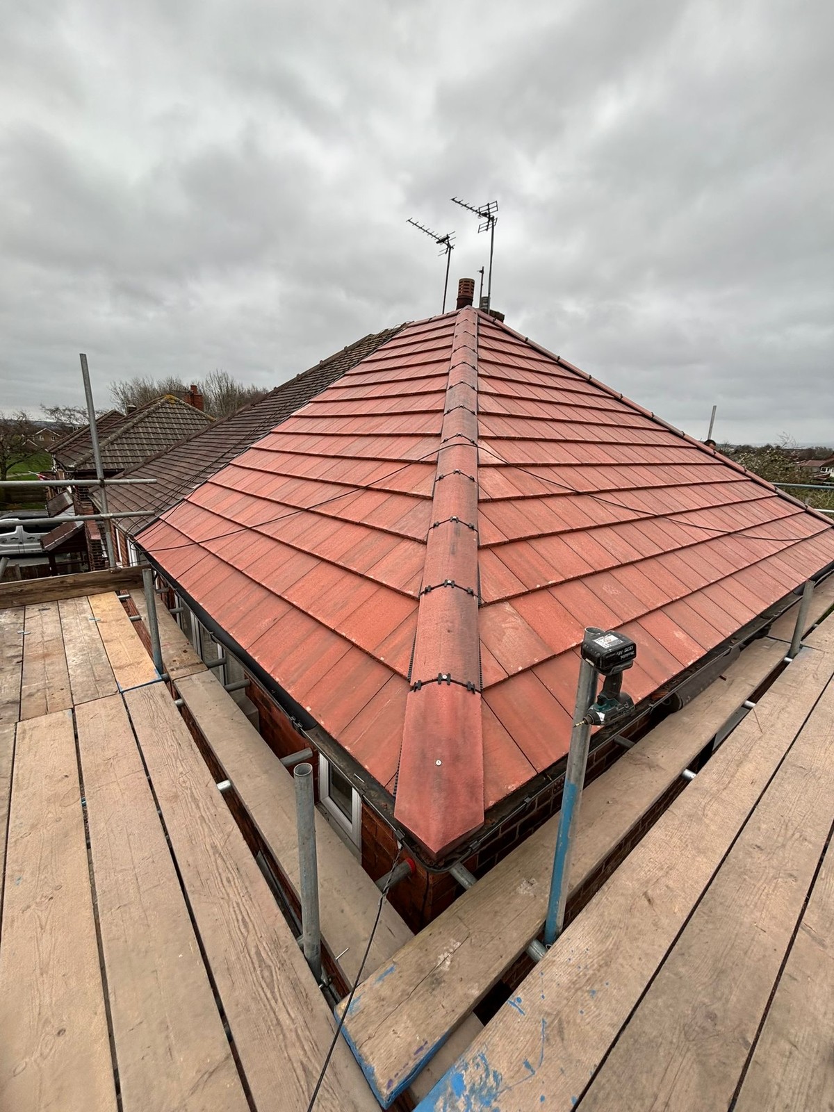 Finished new red-tile hipped roof after re-roofing by Sturgeon's Roofing