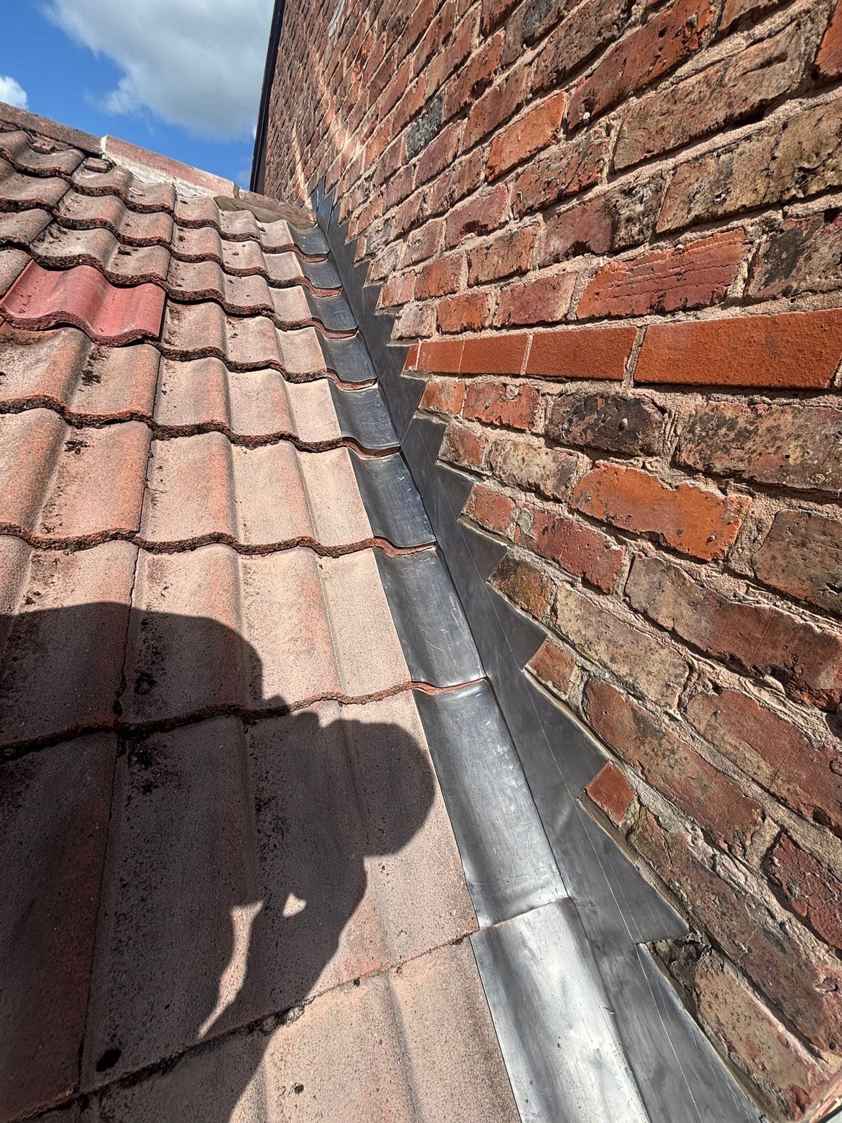 New lead step flashing and abutment after the job by Sturgeon's Roofing