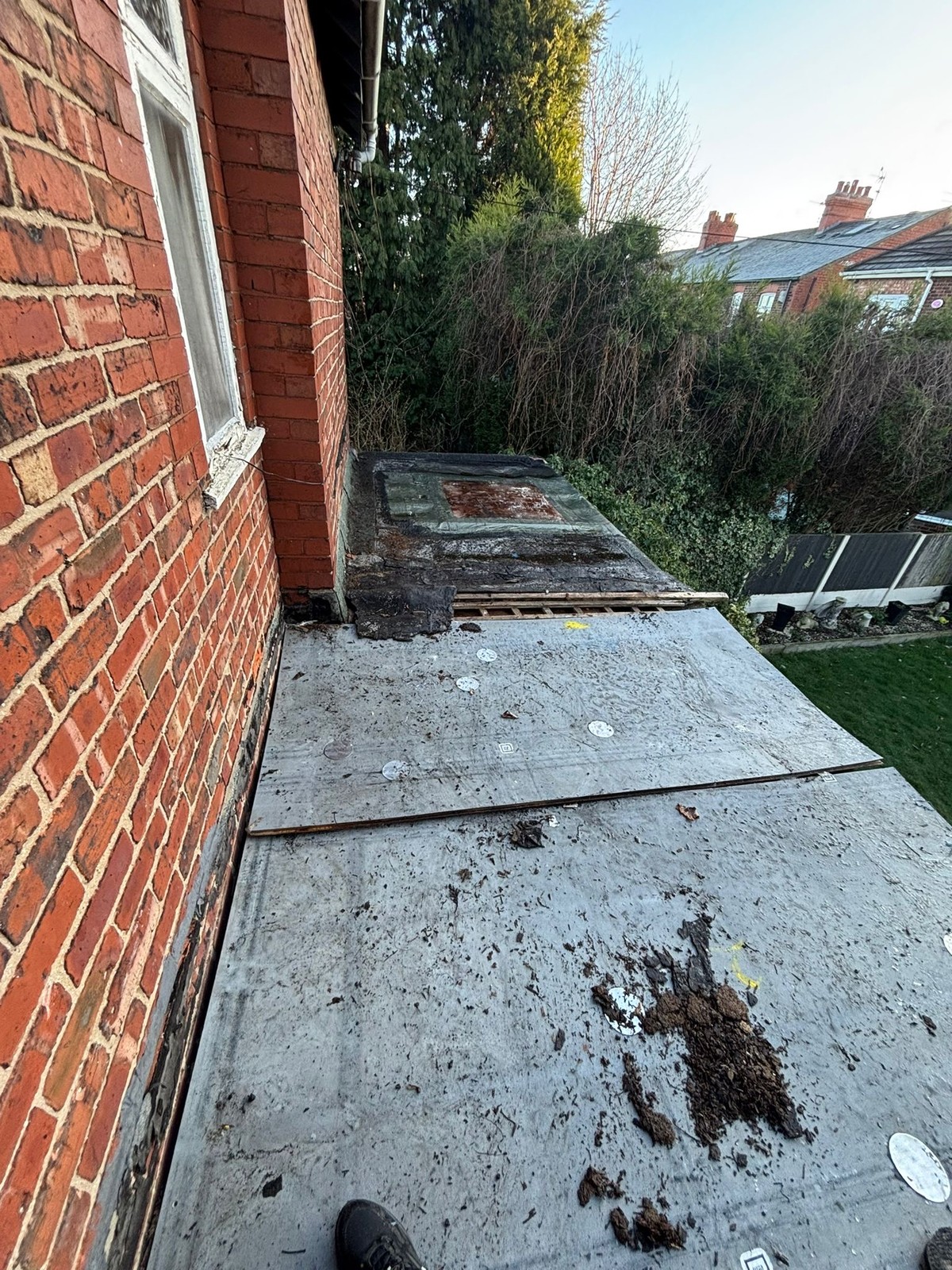 Old worn felt flat roof before the job