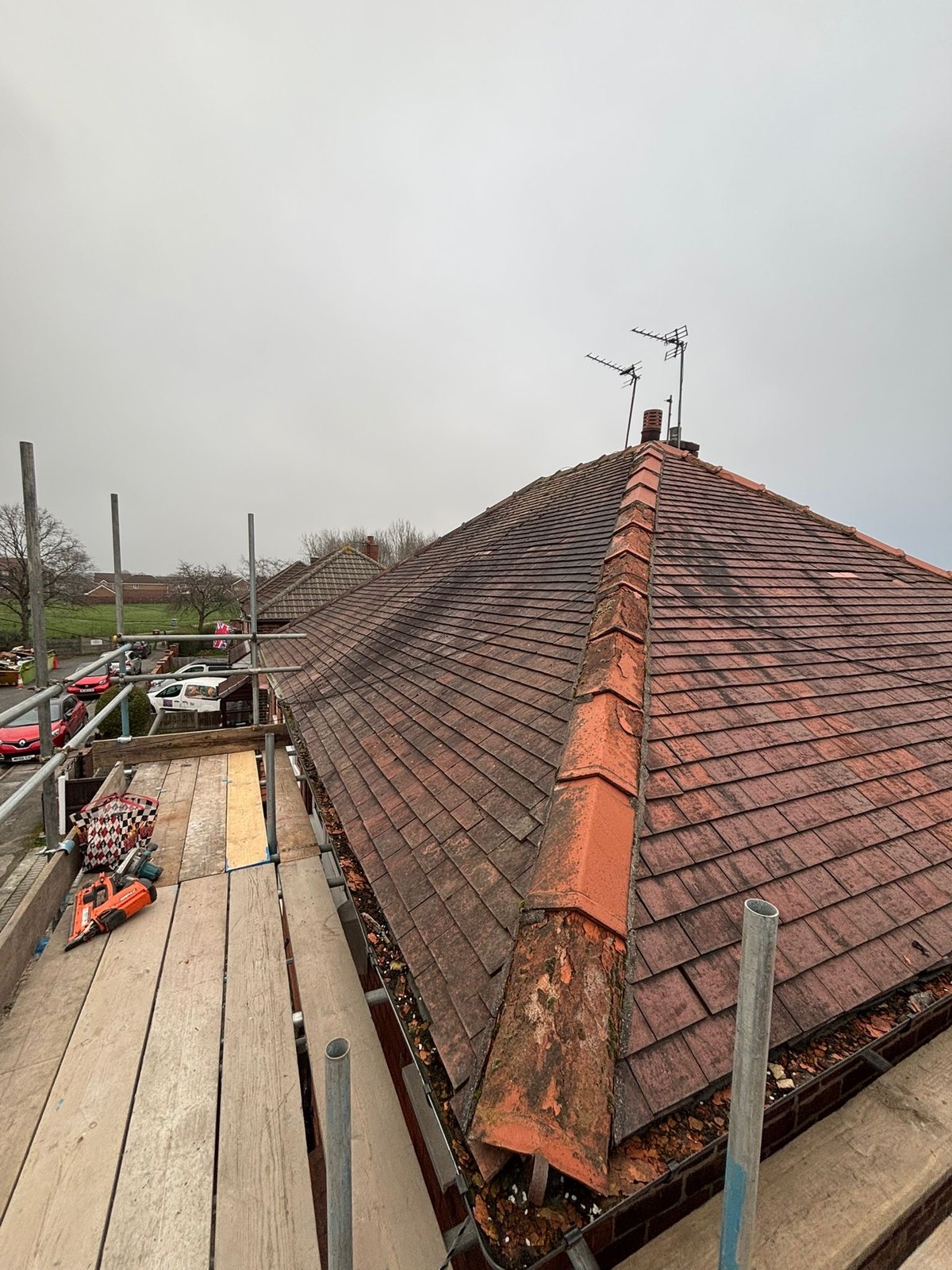 Worn weathered hipped roof before re-roofing